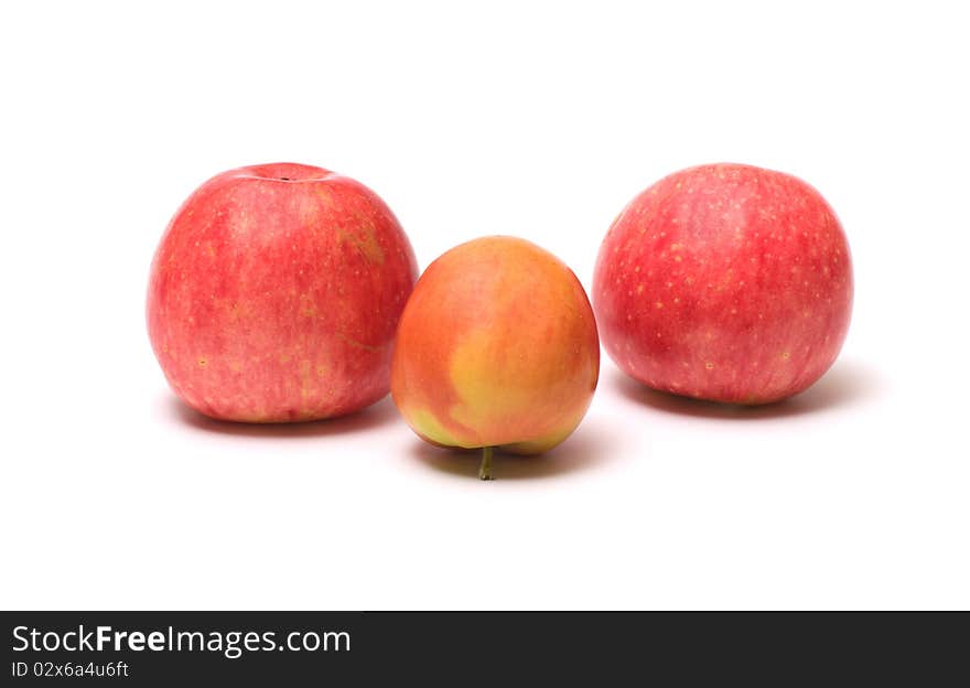 Three ripe apples isolated on a white background. Three ripe apples isolated on a white background.