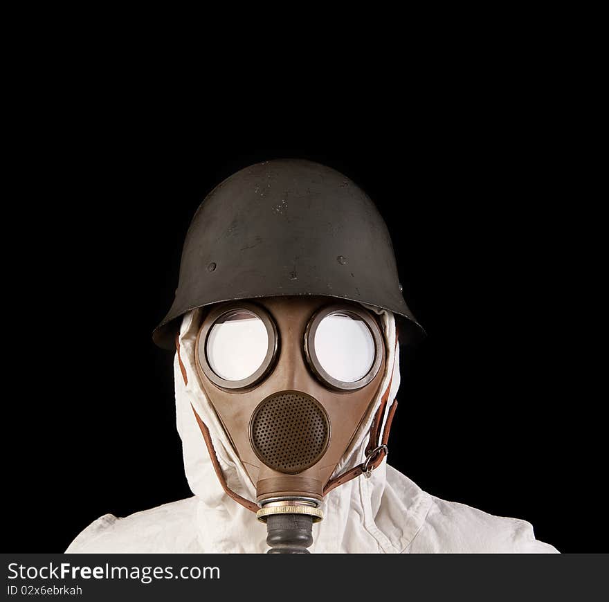 Person in gas mask and helmet on dark background