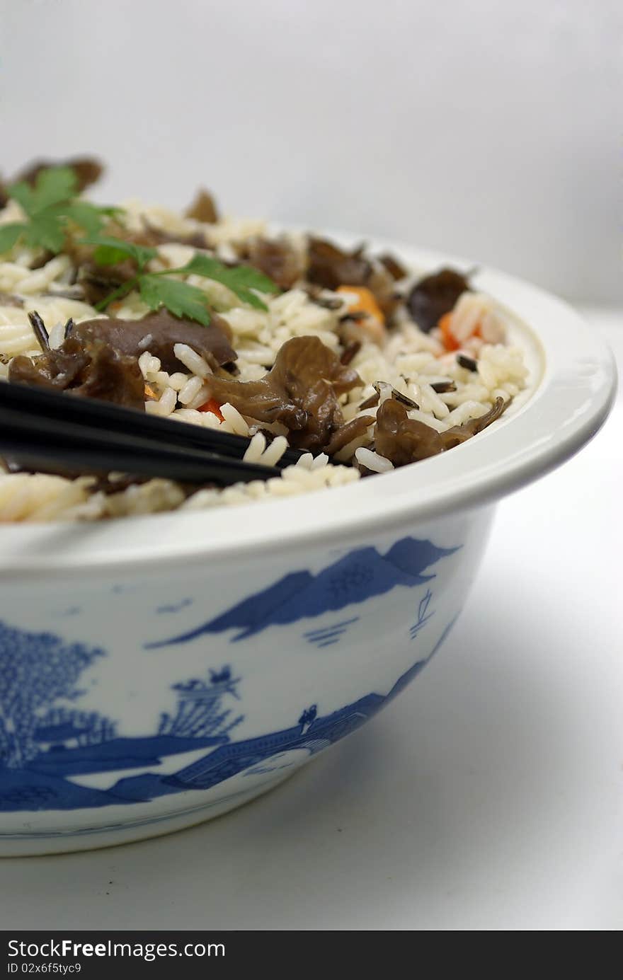 Steamed rice with vegetables served in a chinese porcelain bowl.