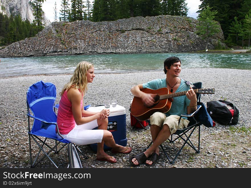 Couple enjoying music on a picnic. Couple enjoying music on a picnic