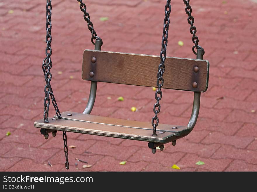 SwingWooden swing on iron chains