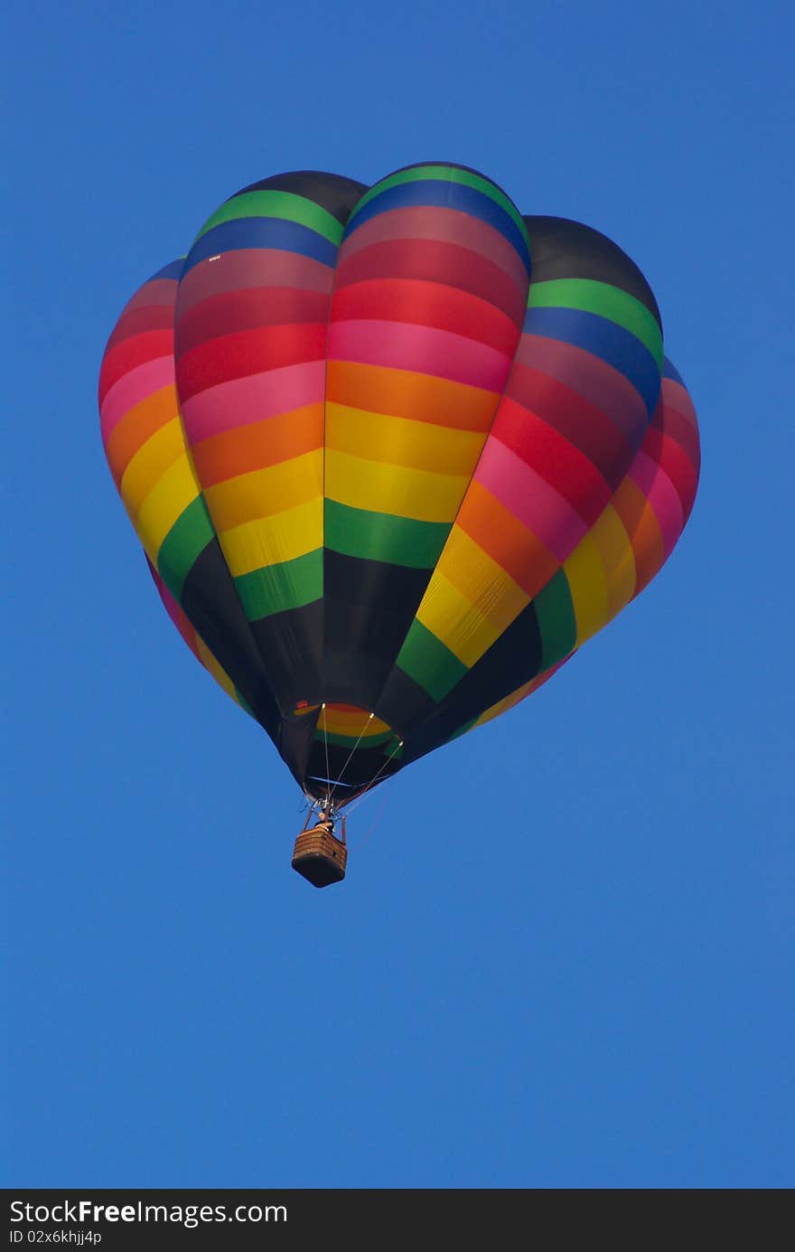 Hot air balloon in flight with clear blue sky background. Hot air balloon in flight with clear blue sky background.