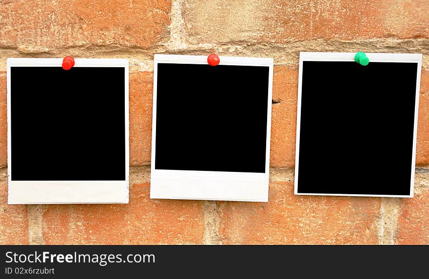 Old photo pressed the red pushpin against a grungy brick wall. Old photo pressed the red pushpin against a grungy brick wall