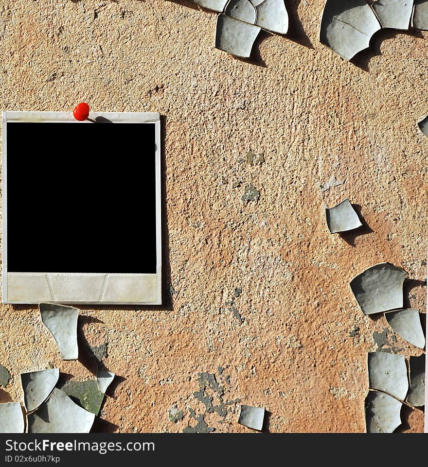 Old photo pressed the red pushpin against a grungy wall. Old photo pressed the red pushpin against a grungy wall