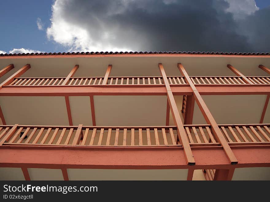 Two wooden balconies agaist dark cloud. Two wooden balconies agaist dark cloud.