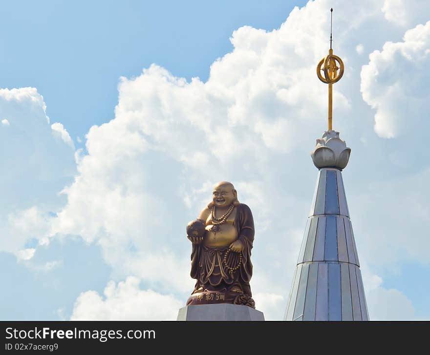 Golden statue and beautiful sky in afternoon