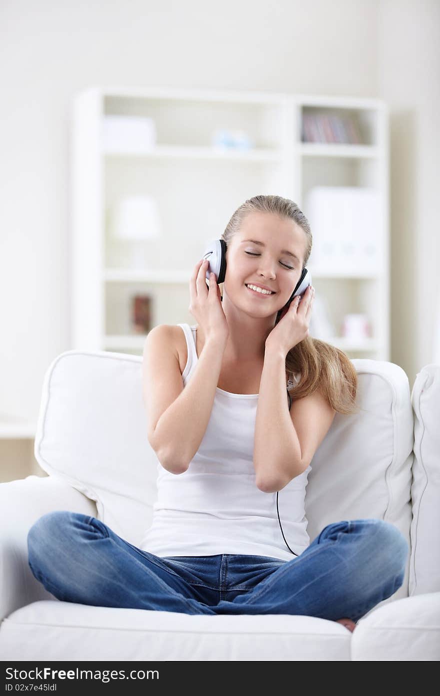 A young girl listens to music on headphones. A young girl listens to music on headphones