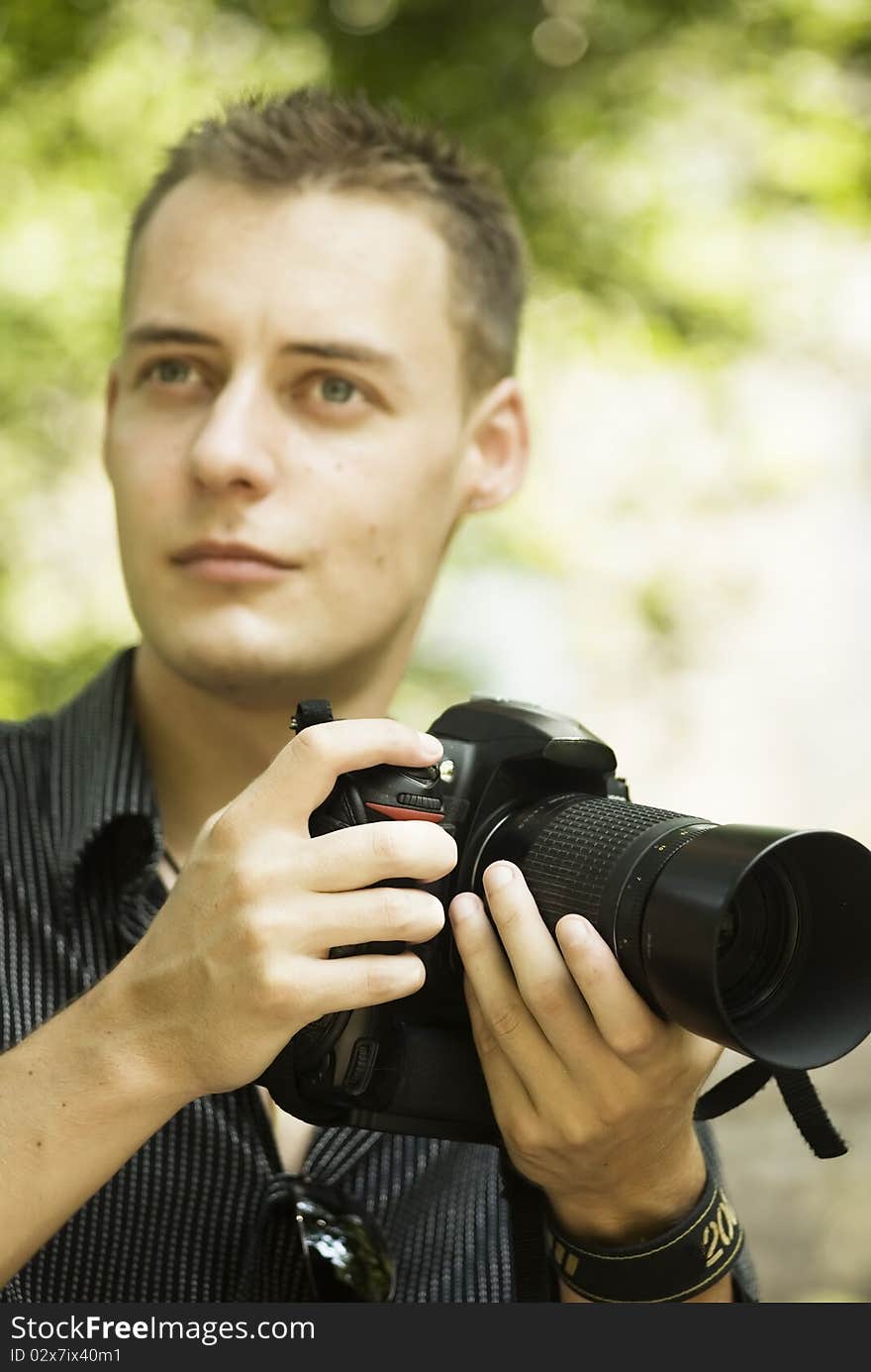 Young photographer in the park with camera