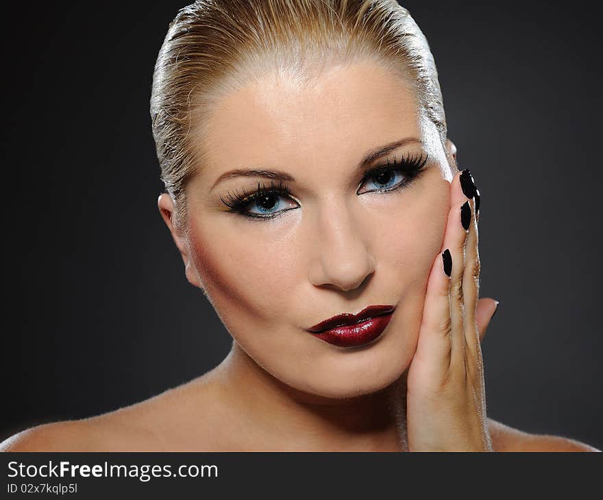 Fall fashion makeup and manicure trend. pretty woman face with perfect lips and black nails