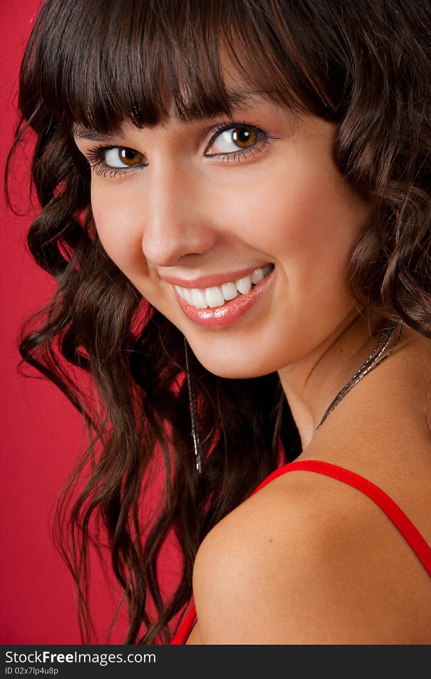 Portrait of beautiful young woman over red background