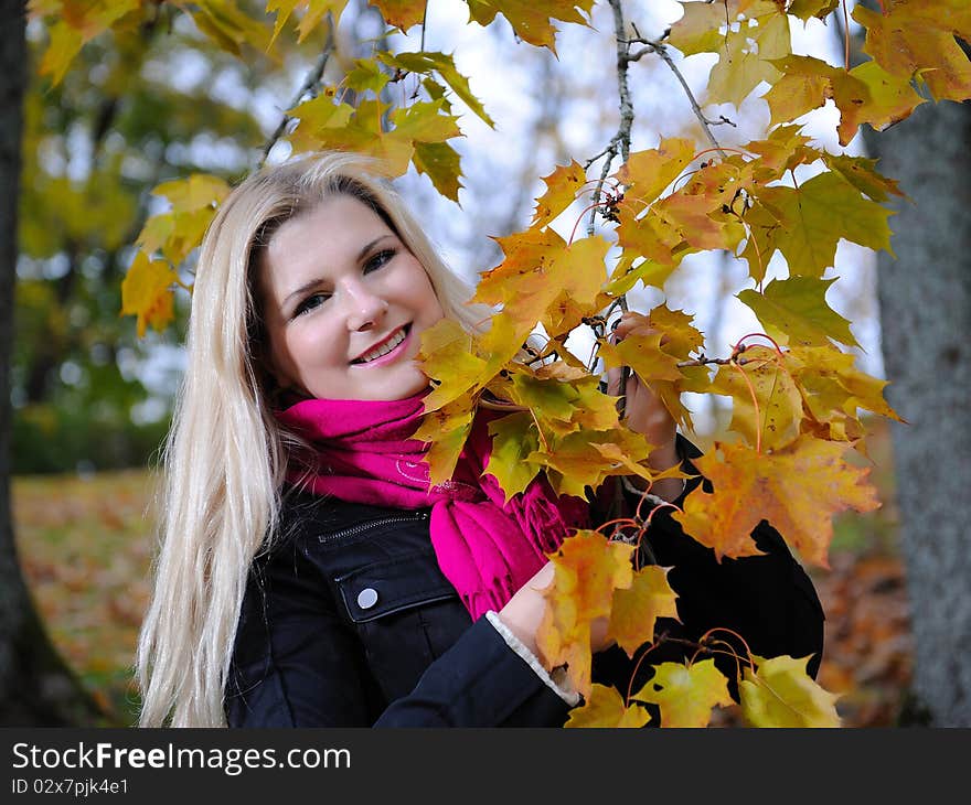 Beautiful autumn woman near yellow tree