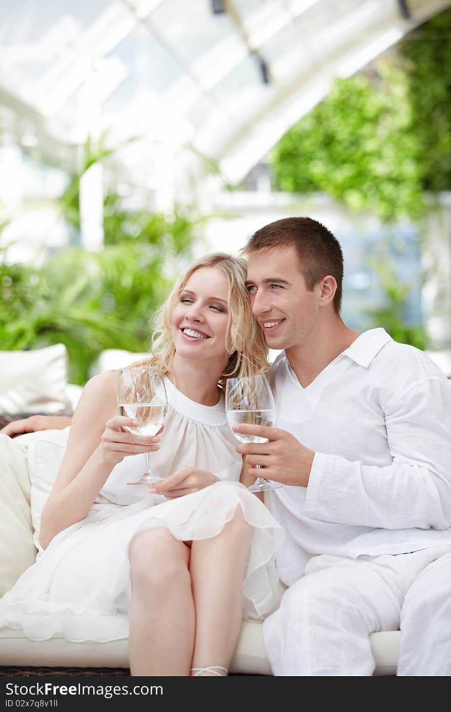 Young attractive couple in a white restaurant