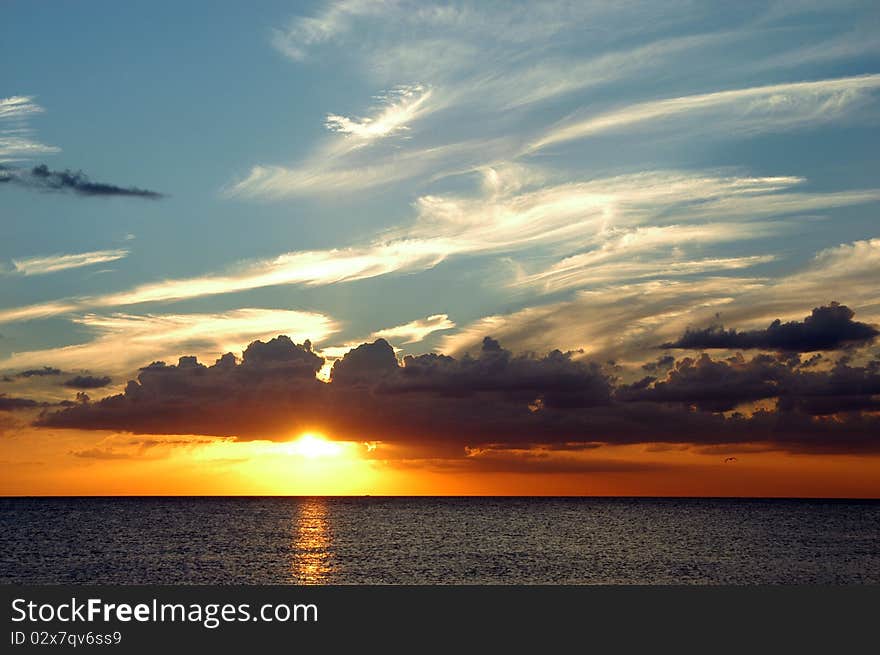 A beautiful sunset in St. Petersburg, Fl at the beach. The clouds, water, and sun, make for a relaxing way to end a busy day. A beautiful sunset in St. Petersburg, Fl at the beach. The clouds, water, and sun, make for a relaxing way to end a busy day.