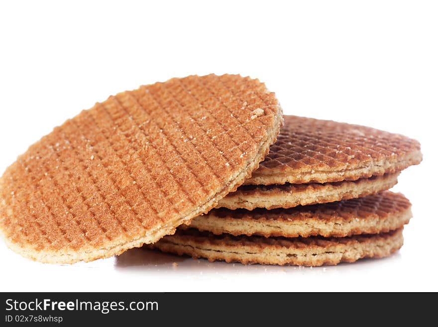 A stack of golden round waffles isolated over white background.