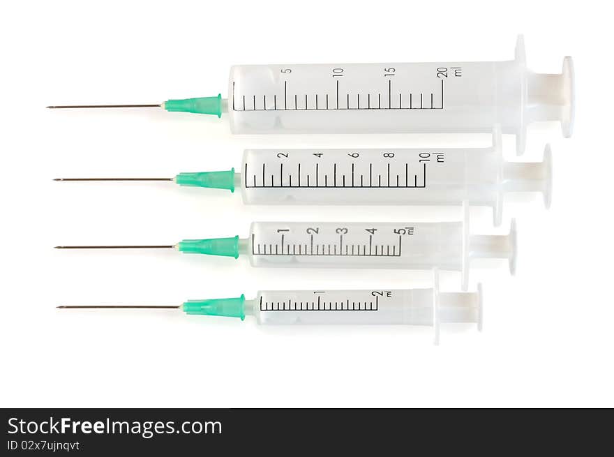 Four disposable syringe against white background