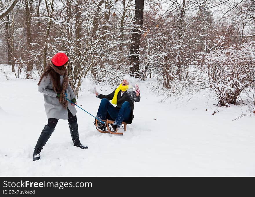 Fun having couple in wintertime sliding on snow. Fun having couple in wintertime sliding on snow