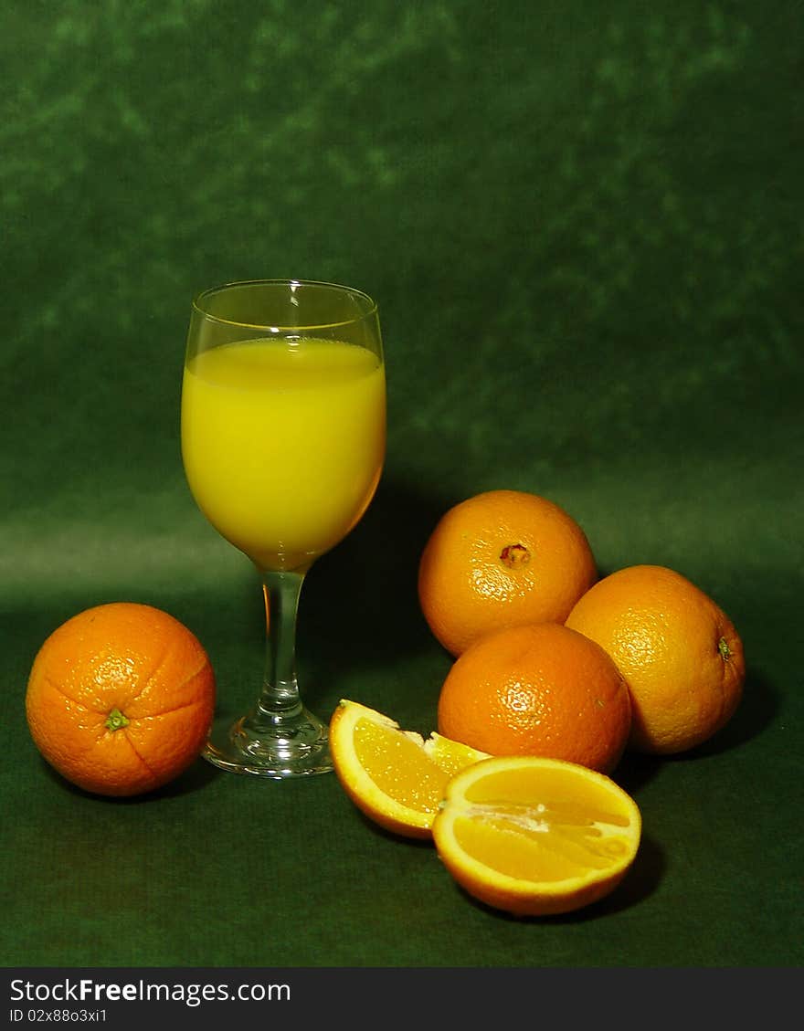 Display of oranges with a glass of fresh squeezed orange juice. Display of oranges with a glass of fresh squeezed orange juice