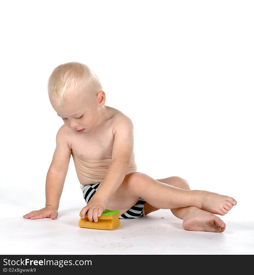 Beautiful baby with a sponge, isolated on white background