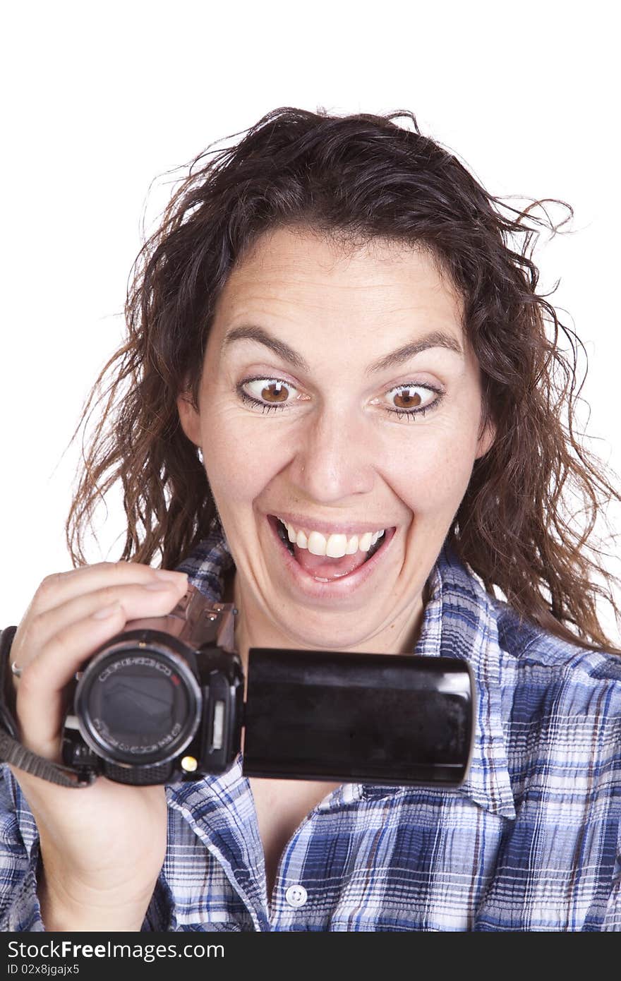 A woman has a video camera and is watching it looking excited. A woman has a video camera and is watching it looking excited.