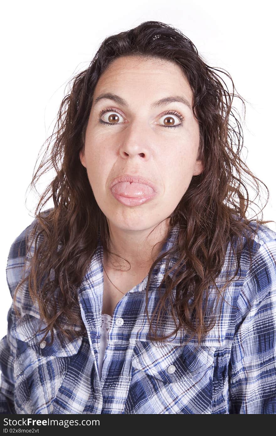 A woman is sticking her tongue out. A woman is sticking her tongue out.