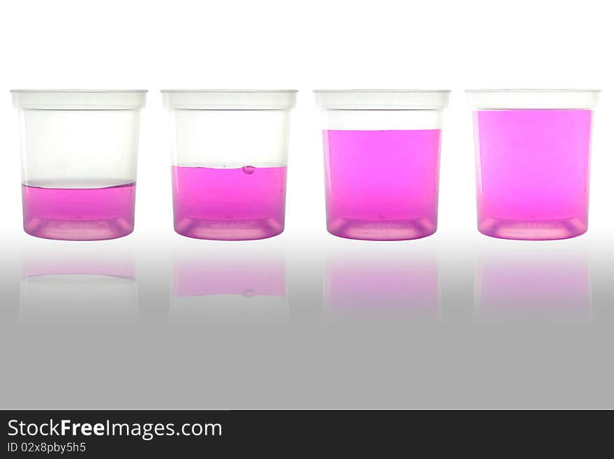 Four cup of pink water for science and drinking. Four cup of pink water for science and drinking.