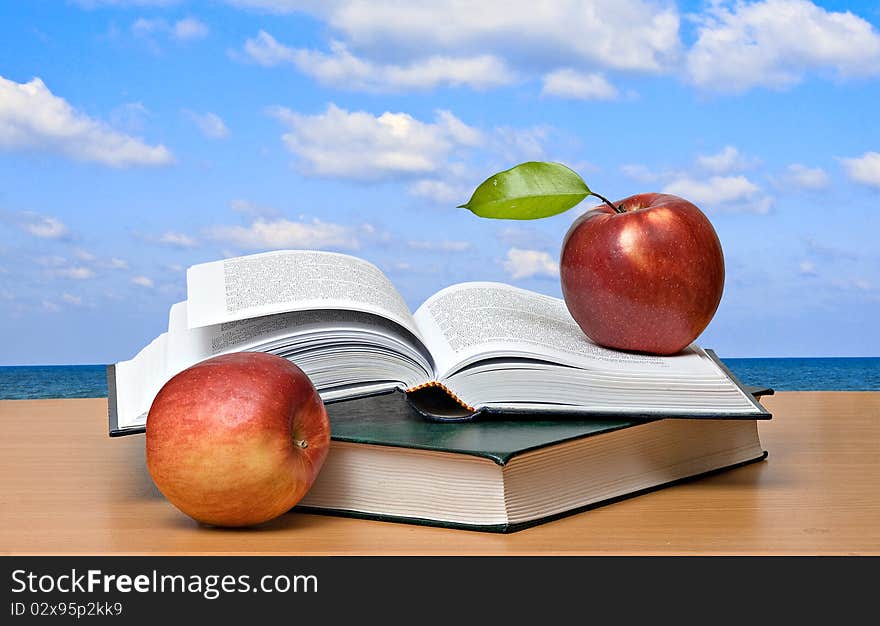 Red apples and open book. Red apples and open book