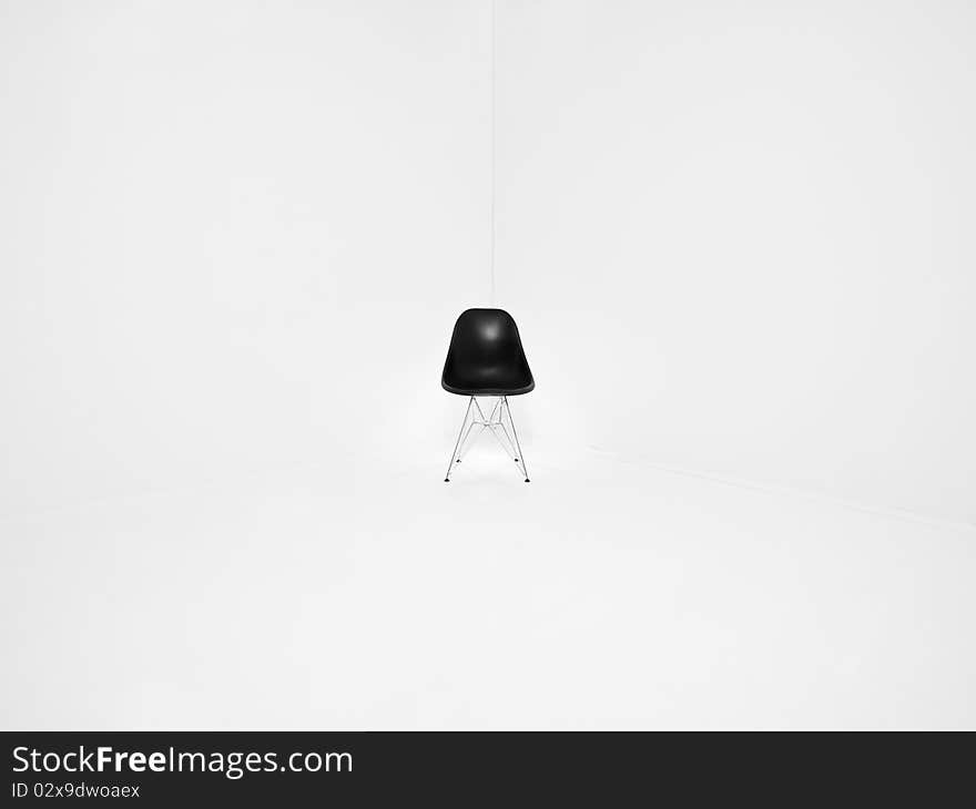 Retro chair in a corner of a white room