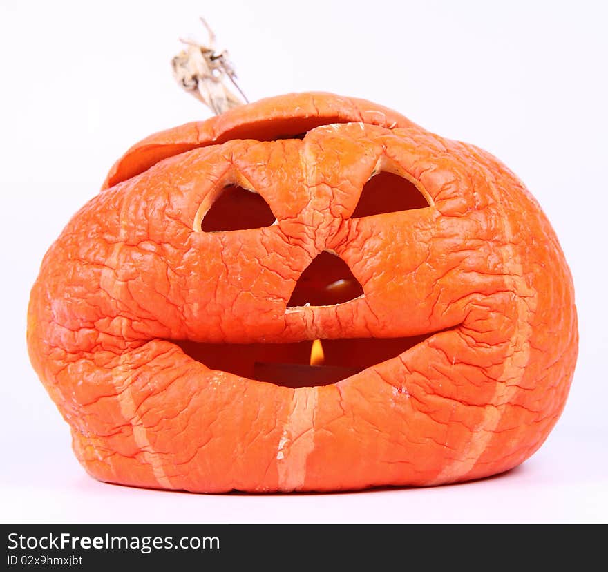 Withered Jack o'lantern on white background