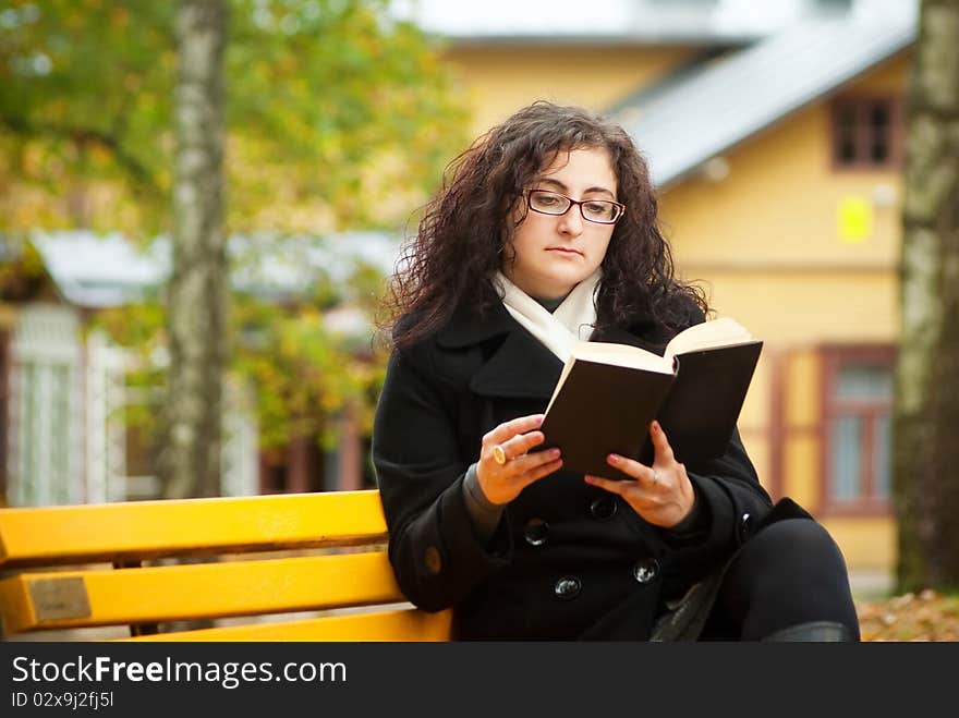 Woman sitting on bench in the yard. Woman sitting on bench in the yard