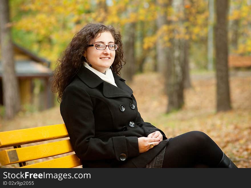 Smilling woman sitting on bench