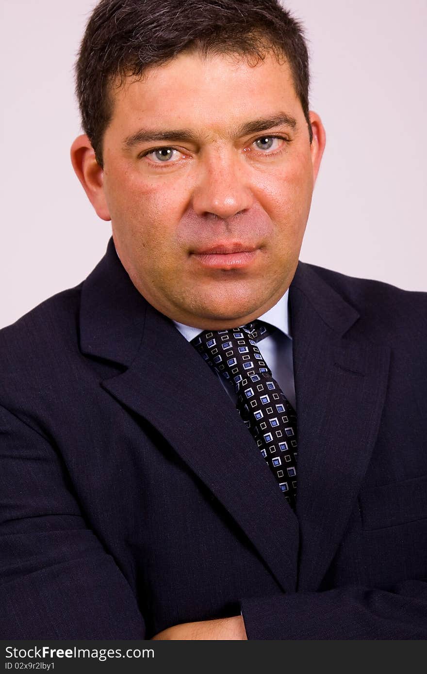 Portrait of a mature business man on a grey background