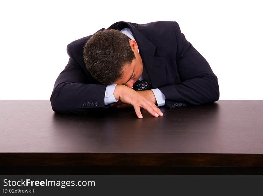 Mature business man sleeping on the desk. Isolated on white