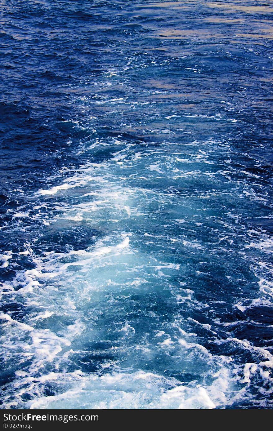 Water waves and splashes behind moving boat. Water waves and splashes behind moving boat