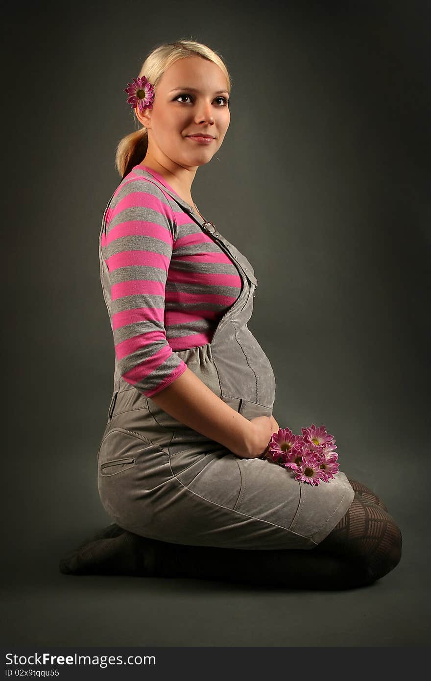 Pregnant young woman on dark background. Pregnant young woman on dark background