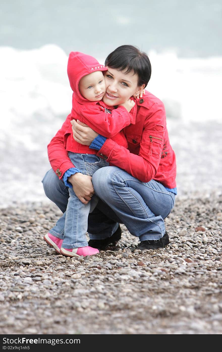 Loving mother and child on sea background