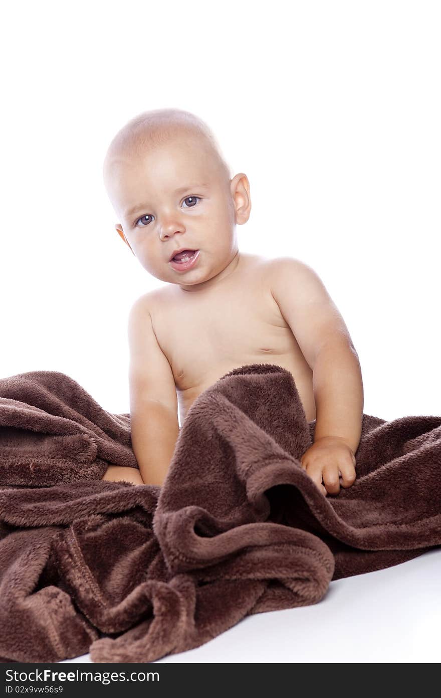 A beautiful baby with brown towel on white