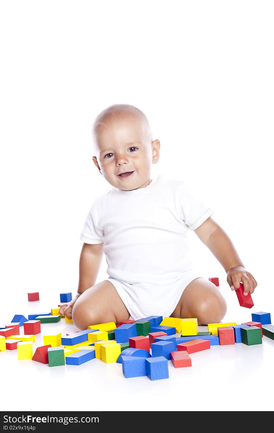 The kid plays with cubes on a white background