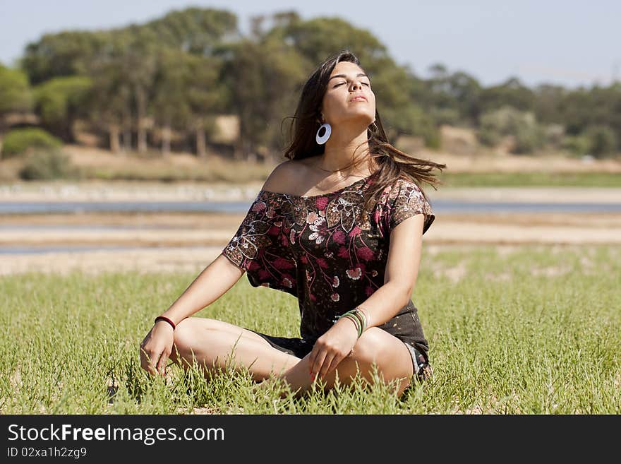 Beautiful girl with floral dress meditating on the nature. Beautiful girl with floral dress meditating on the nature.