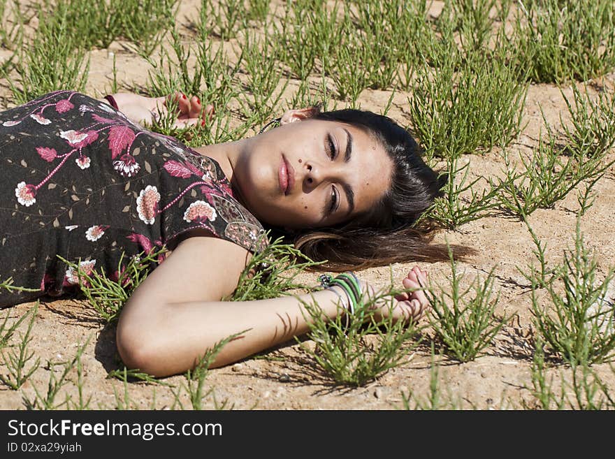 Beautiful girl with floral dress sleeping on the nature. Beautiful girl with floral dress sleeping on the nature.