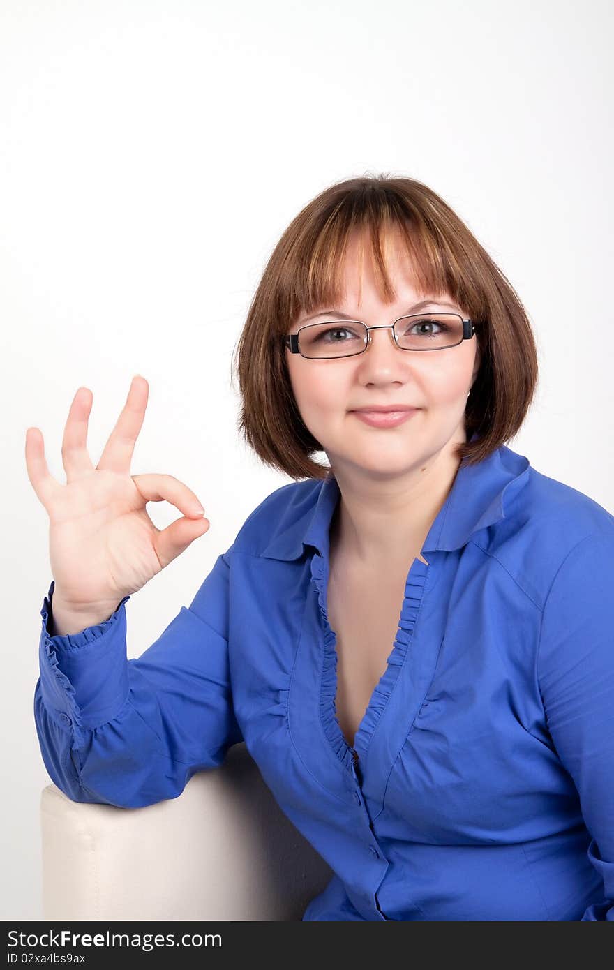 The young woman shows a sign on Ok, On a white background