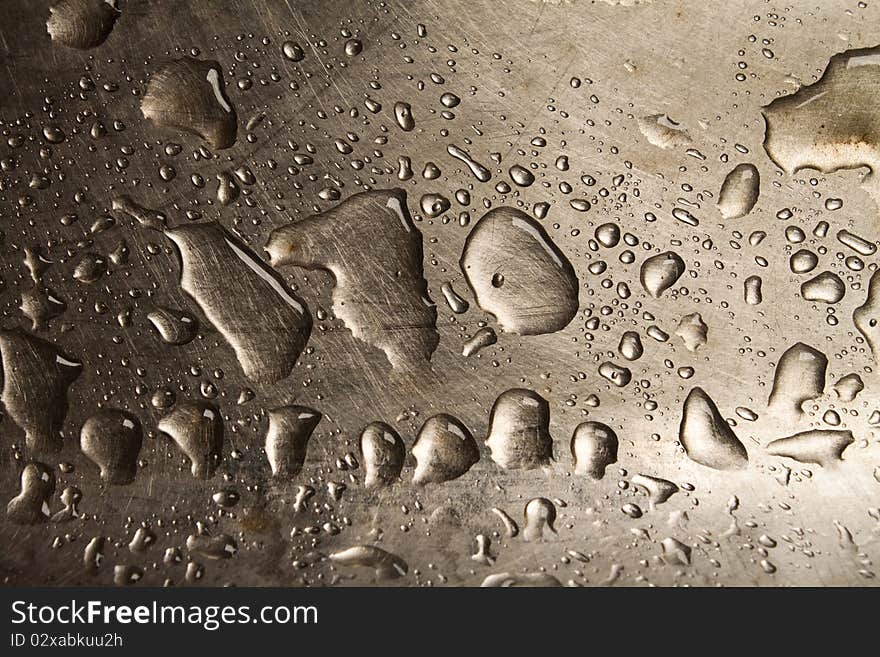 Water drops on the silver metal background