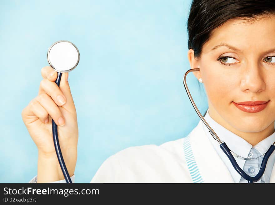 Woman as a doctor holding stethoscope