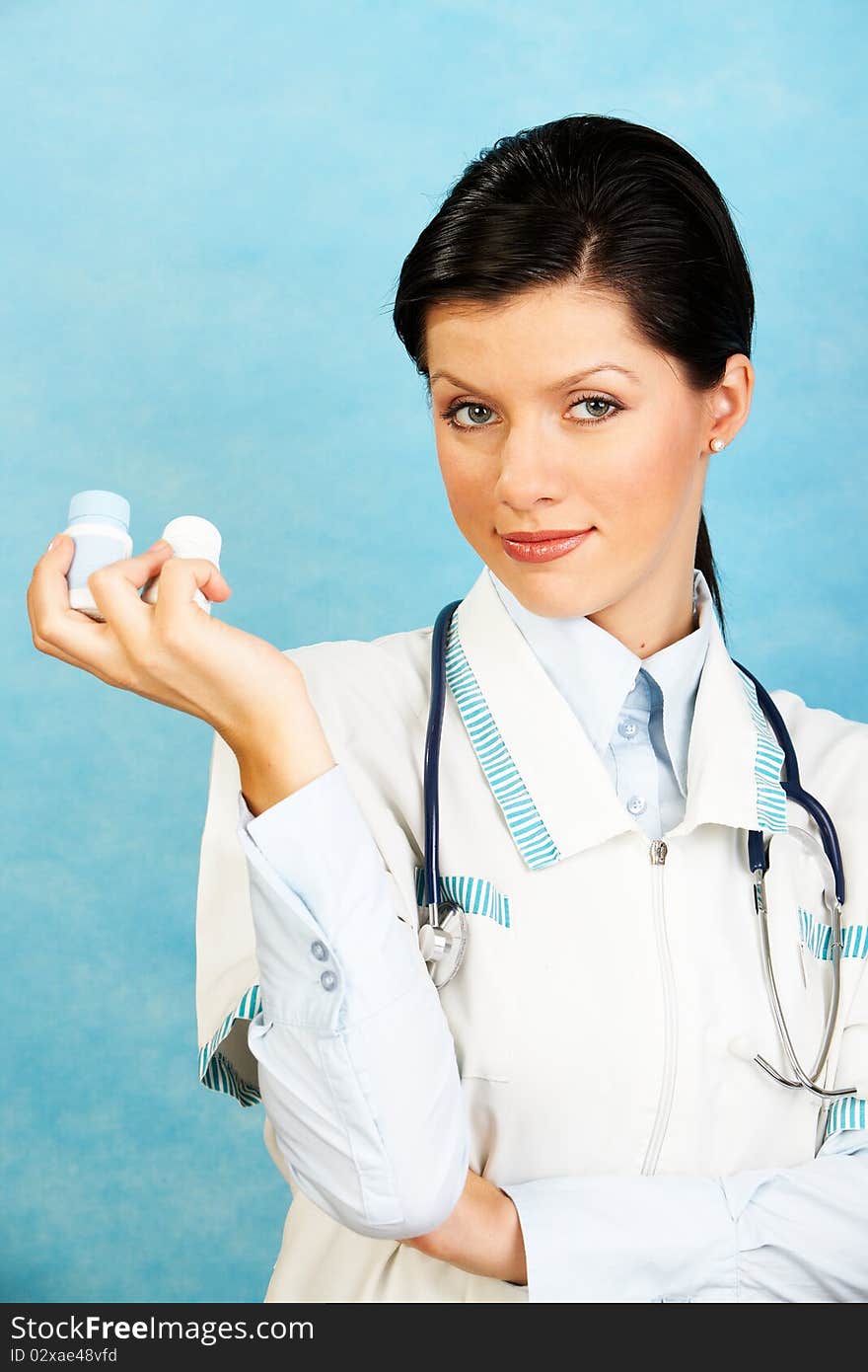 Caucasian woman as a doctor holding meds