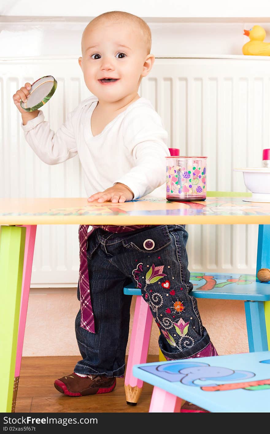 Little girl at the table in the kitchen. Little girl at the table in the kitchen.