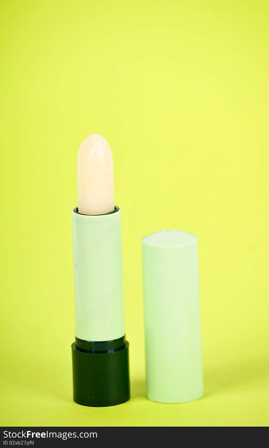 Lipstick isolated on green background