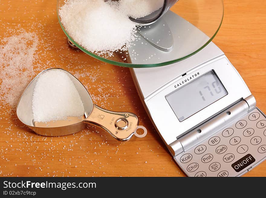 Weighing sugar on scale.