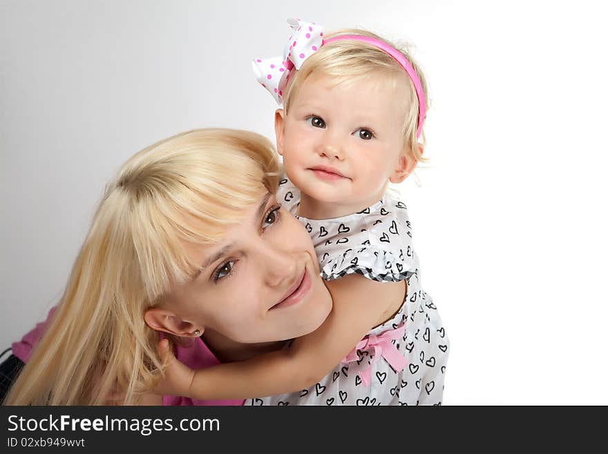 Beautiful child girl playing with toys and her mother. Beautiful child girl playing with toys and her mother