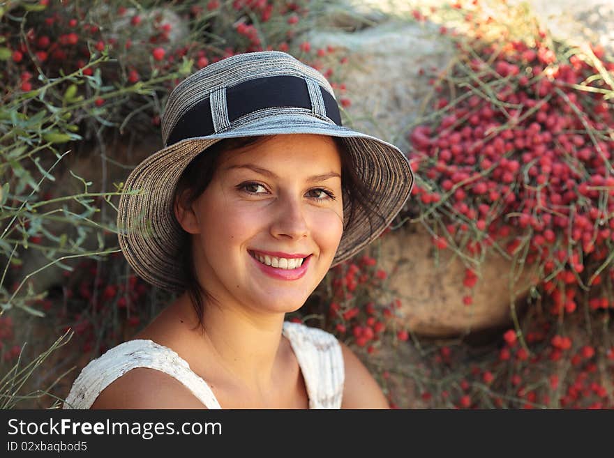 Portrait of the young beautiful woman in a hat