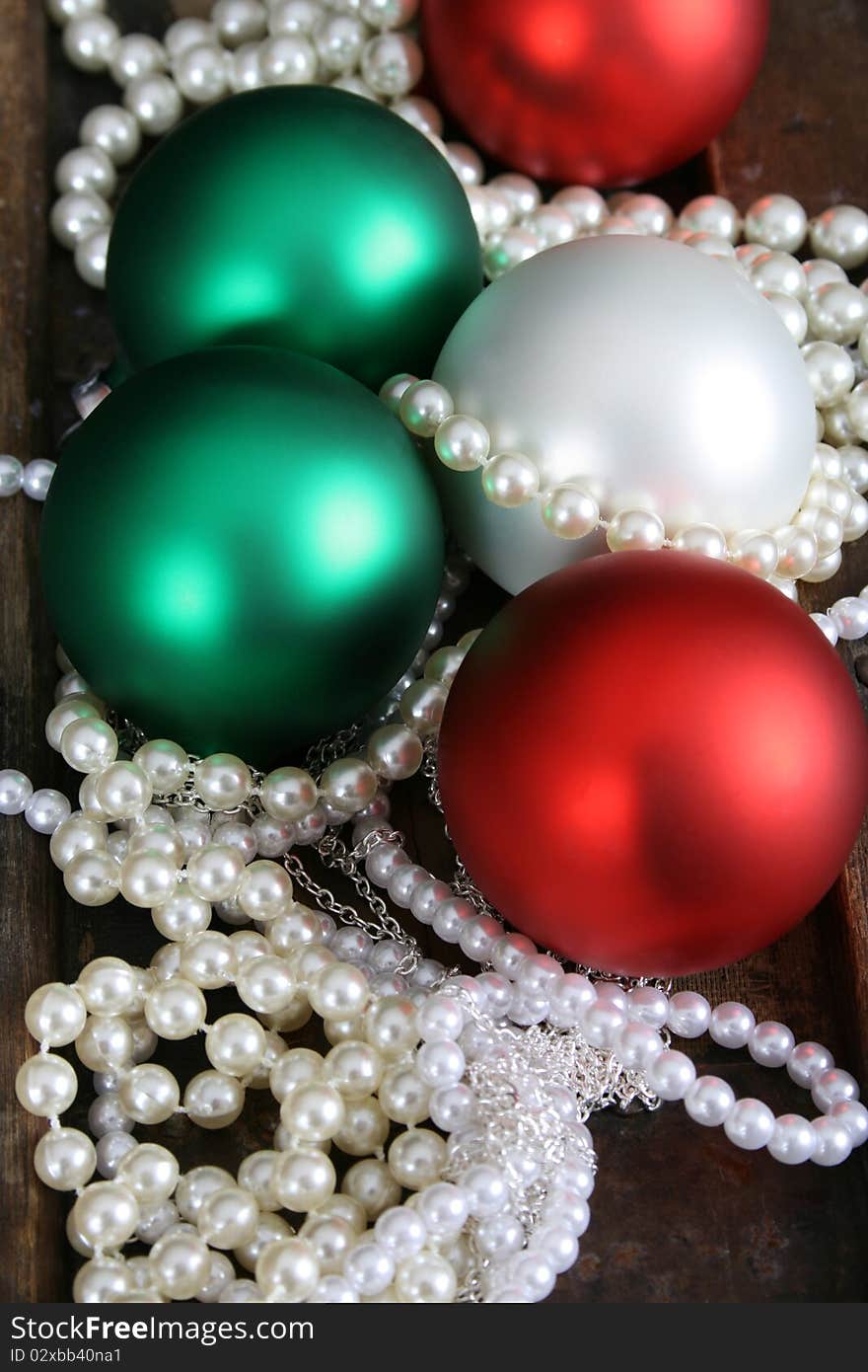 Christmas decoration balls and pearl jewellery necklaces. Christmas decoration balls and pearl jewellery necklaces