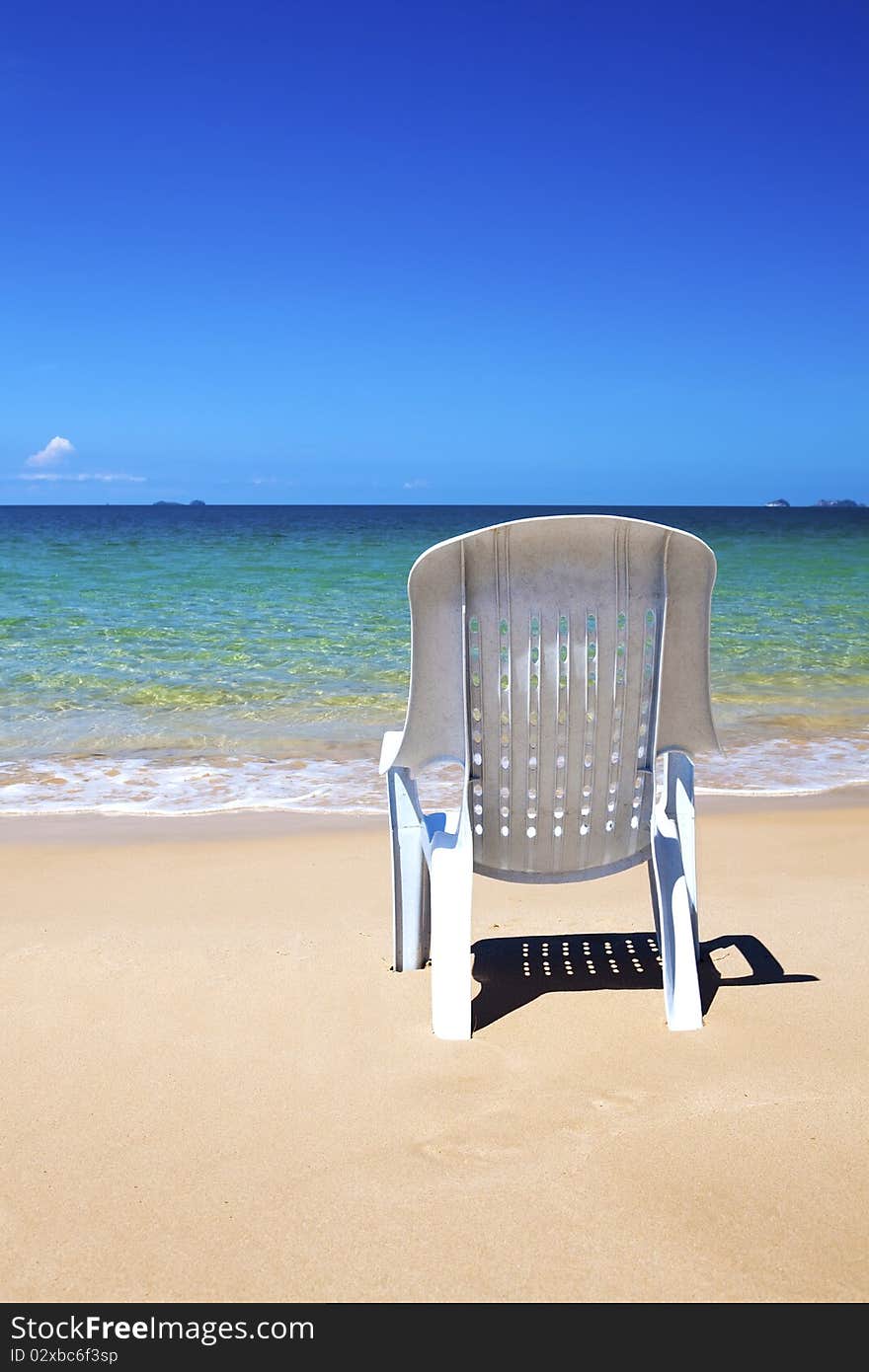 Plastic chair looking out to the ocean.